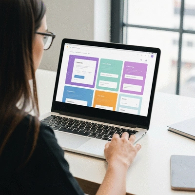 Person creating a lead capture page on a laptop, showing website elements being dragged and dropped.